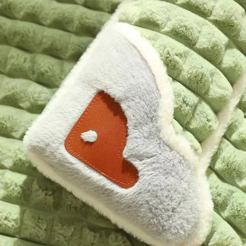 Green dog bed with a brown heart on the edge