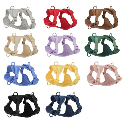 Collection of dog harnesses in various colors on a white background