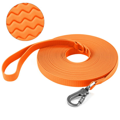 Orange dog leash with textured handle and metal clip on a white background